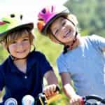 Portrait of cheerful kids riding bikes